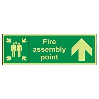 Image of VSafety 17023BJ G&quot;Fire Assembly Point Arrow Up&quot; Sign, Glow In Dark, 1 mm Plastic, Landscape, 450 x 150 mm, Green