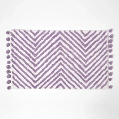 Image of HOMESCAPES Lilac Cotton Bath Mat with Zig Zag Design Super Absorbent Tufted Bathmat Pom Poms, 50 x 80 cm