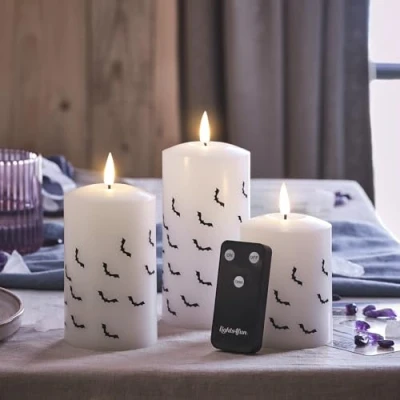 Image of Lights4fun Set of 3 TruGlow® Battery Operated LED Flameless Pillar Candles Halloween Party Decoration Black Bat Print Real White Wax with Remote Control Indoor Use