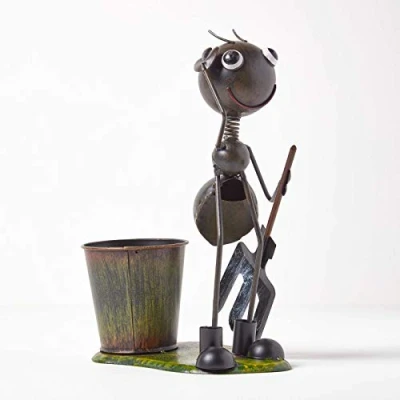 Image of HOMESCAPES Metal Garden Ant Ornament Holding Digging Fork with Small Rustic Flower Pot, Handcrafted From 100% Iron Set on Green Standalone Base, 32 cm Tall