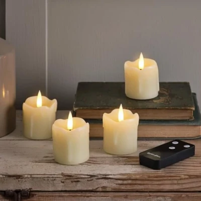 Image of Lights4fun Set of 4 TruGlow® Real Ivory Dripping Wax Votive Tea Lights Battery Operated LED Flameless Candles with Timer and Remote Control Indoor Use