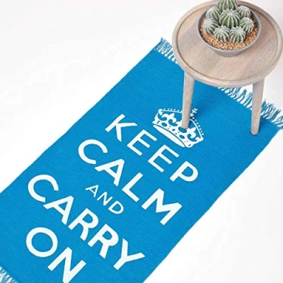Image of HOMESCAPES Rugs For Bedroom, Handwoven &#039;Keep Calm and Carry On&#039; Nostalgic Blue &amp; White Living Room Area Rug, Ultra Soft 100% Cotton Carpet, Hand Block Printed 60 x 100 cm
