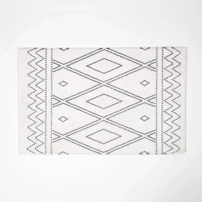 Image of HOMESCAPES Black and White Cotton Bath Mat with On Trend Boho Design Super Absorbent Tufted Bathmat, 50 x 80 cm