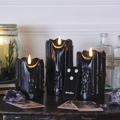 Image of Lights4fun Set of 3 TruGlow® Battery LED Flameless Pillar Candles Heavy Dripping Black Real Wax with Timer and Remote Control Indoor Use