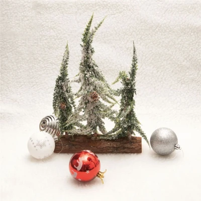 Image of Decorative Snow Topped Mini Christmas Tree Display on Log 3 Trees of Varying Heights