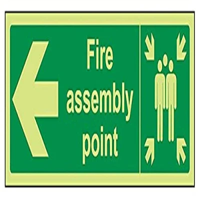 Image of VSafety 17021AX G &quot;Fire Assembly Point Arrow Left&quot; Sign, Glow In Dark, 1 mm Plastic, Landscape, 300 x 100 mm, Green