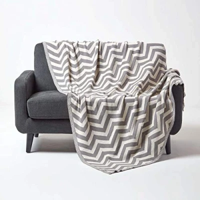 Image of HOMESCAPES Grey Knitted Throw Soft Cotton Geometric Blanket Handwoven Warm and Cosy Silver Off White 100% Chevron Herringbone Sofa Bed Throw, 130 x 170 cm