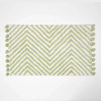 Image of HOMESCAPES Sage Green Cotton Bath Mat with Zig Zag Design Super Absorbent Tufted Bathmat Pom Poms, 50 x 80 cm