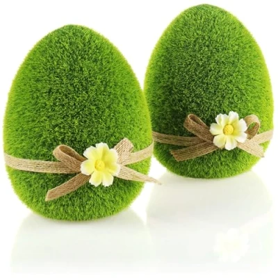 Image of com four® 2x decorative figures Easter egg with bow and flowers green for spring ceramic eggs covered artificial grass (2 x 15cm)