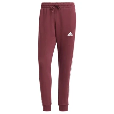 Image of adidas Men&#039;s Essentials Fleece 3 Stripes Tapered Cuff Pants, Shadow red, L Short