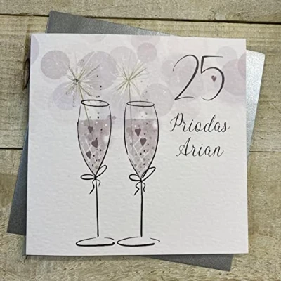 Image of White Cotton Cards 25 PRIODAS ARIAN (SILVER WEDDING ANNIVERSARY) FLUTES WITH SPARKLER WELSH ANNIVERSARY CARD, HANDFINISHED (W DA25)
