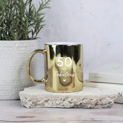 Image of eBuyGB Shiny Gold Mug, 50 &amp; Fabulous Ceramic Coffee Cup, Milestone Birthday, 50th Birthday Gift for Her, Sister, Mum, Auntie