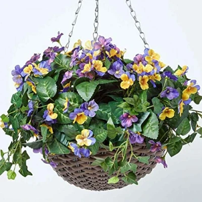 Image of HOMESCAPES Purple and Yellow Pansy Artificial Hanging Basket Lifelike Plant For Indoor Outdoor Decoration Trailing Flowers In Brown Wicker Pot with Silver Metal Chain Hook 60 cm Long
