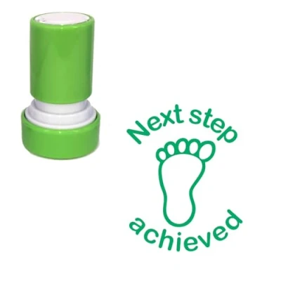 Image of Next Step Achieved Self Inking Teacher Stamp. Green Ink. Footprint Design. 22mm. Reinkable