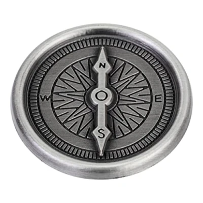 Image of Compass travel token with &#039;Stay safe on your travels&#039; message reverse